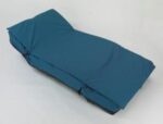 A blue folding mattress laid out flat on a neutral background.