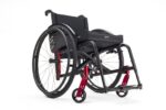 Black wheelchair featuring red accents and a padded seat cushion.