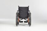 Black wheelchair with orange accents, viewed from the back, featuring large rear wheels.