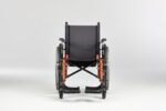 A black wheelchair with orange accents, featuring large rear wheels and footrests.