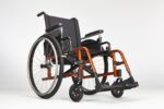 Manual wheelchair featuring a black seat and an orange frame with large rear wheels.
