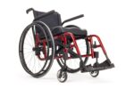 Red lightweight wheelchair with black seat and armrests, featuring large rear wheels and footrests.