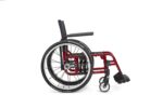 A red lightweight wheelchair with black armrests and large wheels, shown from the side.