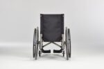 Black wheelchair viewed from the back, featuring large rear wheels and a simple design.