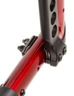 Close-up view of a red Catalyst 5VX camber spacer with black mounting hardware.