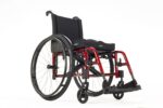 Red lightweight wheelchair with a black seat cushion and large rear wheels.