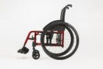 Candy red Catalyst 5VX wheelchair shown from the left side with black seat and wheels.
