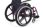 Purple wheelchair featuring large black wheels and a compact design for mobility.