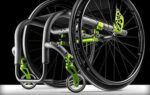 A lightweight wheelchair featuring a sleek design with green accents and large wheels.