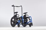 A blue folding wheelchair with black seating and handles, positioned on a neutral background.