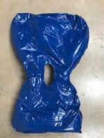 A blue plastic cover with a hole in the centre, laid flat on a surface.