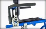 Close-up of integrated swing away arms on a mobility chair, showing the armrest and mounting mechanism.