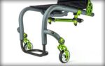 A grey and green wheelchair frame featuring four wheels and a minimalist design.