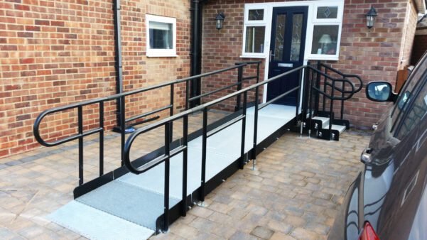 Image: Wheelchair ramp leading to someones front door, the ramp is painted black and matches the building nicely 0121 630 3850