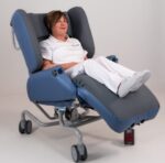 A woman sits in an Air Comfort Deluxe getting pressure relief