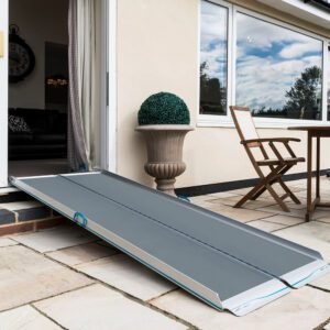 Image: a folding wheelchair access ramp which is super light is shown in the doorway of a patio door