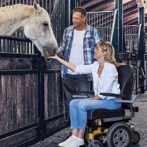 Home 1 Younique Healthcare & Mobility | Wheely Good Wheelchairs in the West Midlands | 0121 630 3850 Man and Woman on Dietz Sango Slimline MWD Interacting with Horse