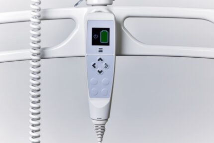 Digital handset with buttons and battery indicator for medical equipment control.