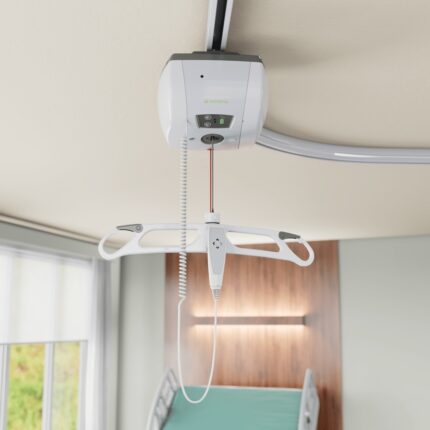 M-Series ceiling lift system with a control pendant and lifting mechanism mounted on the ceiling.
