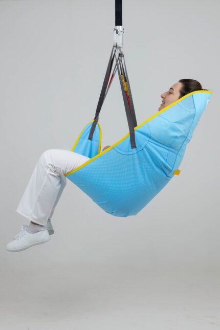 A blue disposable high easy sling with a person seated inside, suspended from a support system.