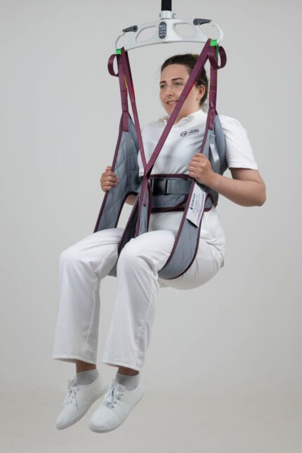 A padded sling designed for lifting patients, shown in use by a healthcare professional.