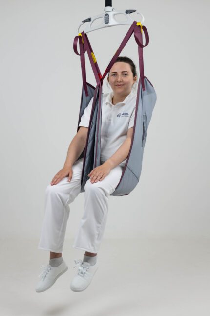 Padded leg sling used for lifting patients, featuring a grey fabric and maroon straps, with a seated model demonstrating its use.