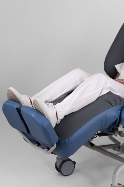 Foot rest attached to the Air Comfort Deluxe V2 chair with a person’s feet resting on it.