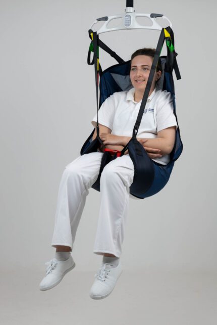A person seated in an in-situ deluxe leg and head support device, suspended in the air.