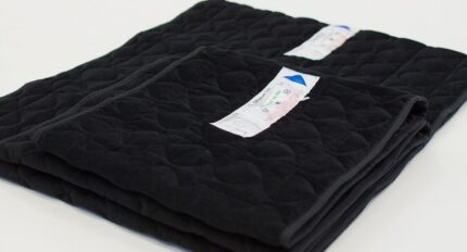 Two black one-way slide sheets stacked on top of each other with labels visible.