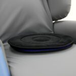 Black cushioned seat disc placed on a grey chair, featuring a circular design with a smooth surface.