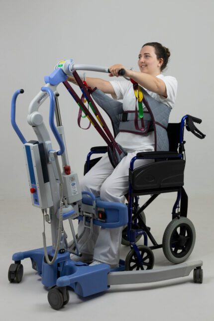 A person using a patient transporter sling attached to a wheelchair for mobility assistance.