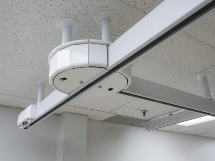 Turntable device mounted on a ceiling with a battery compartment visible.