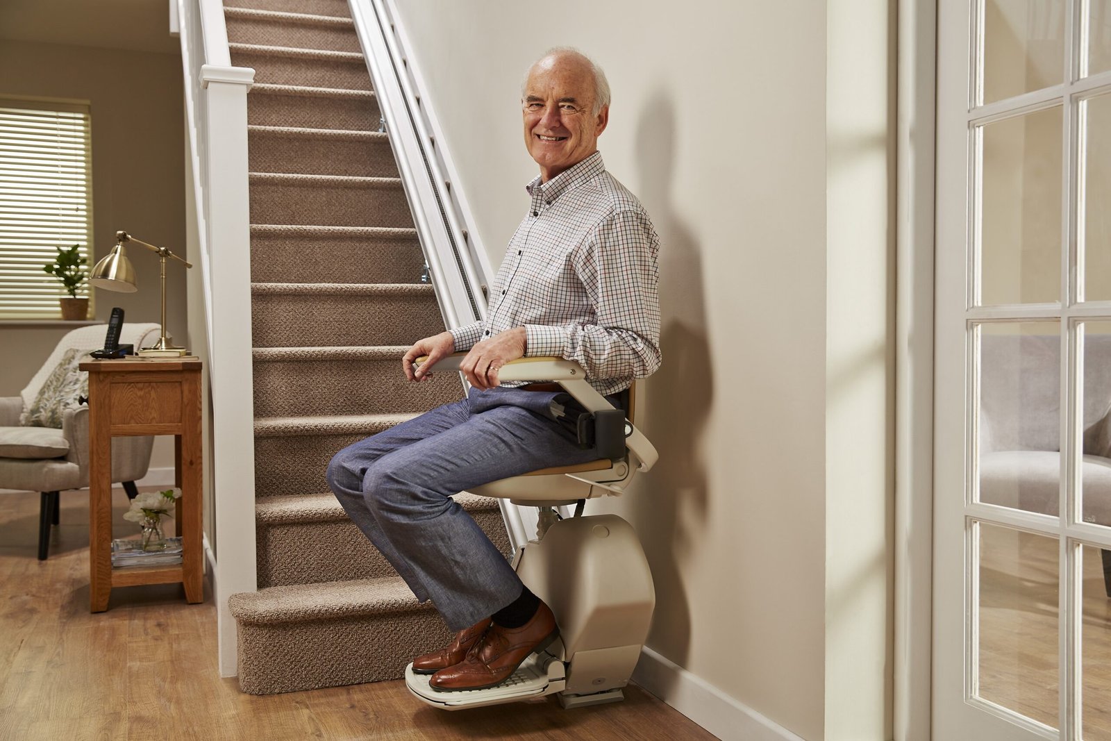 Person using a stairlift inside a home