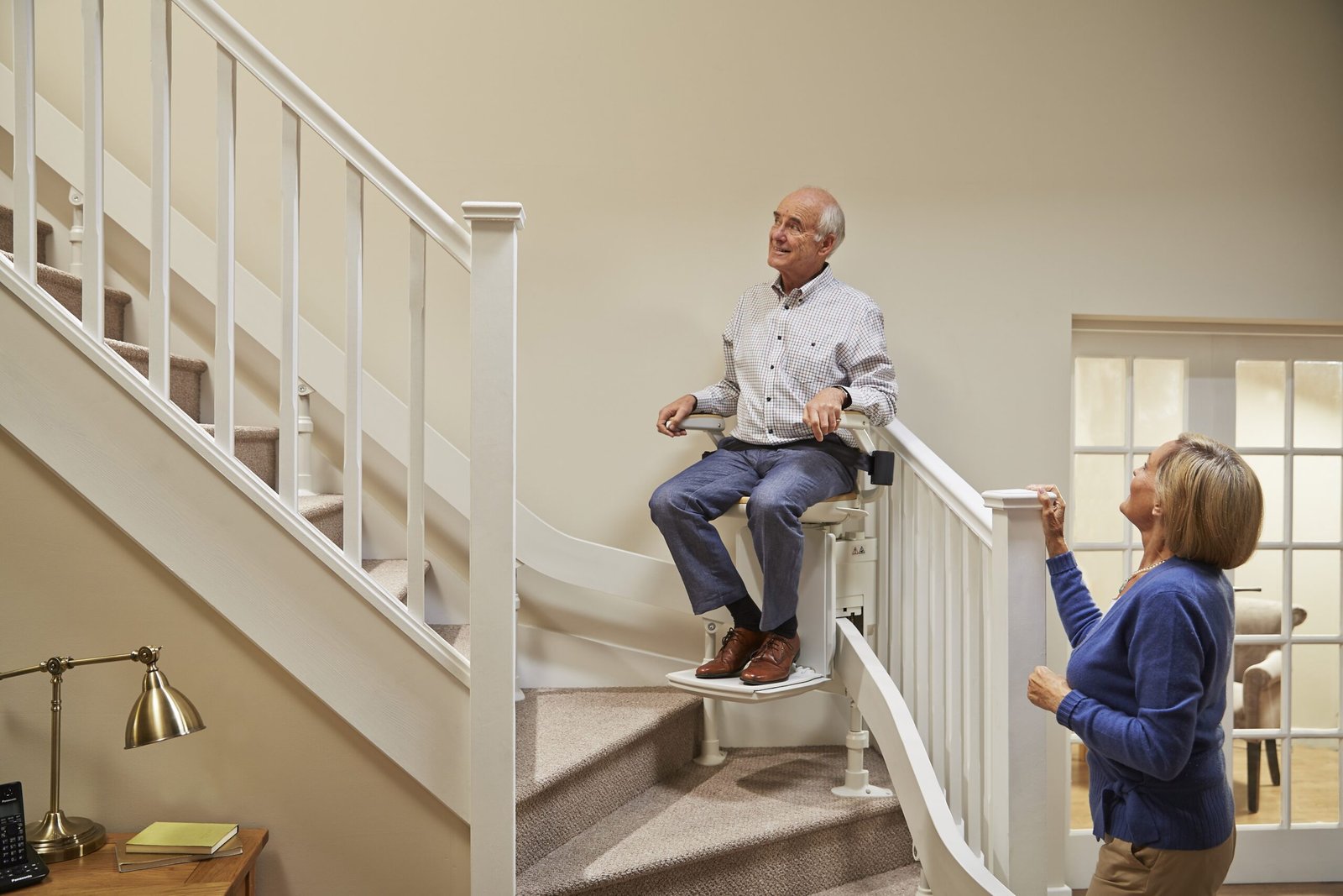 Stairlift user with support person nearby